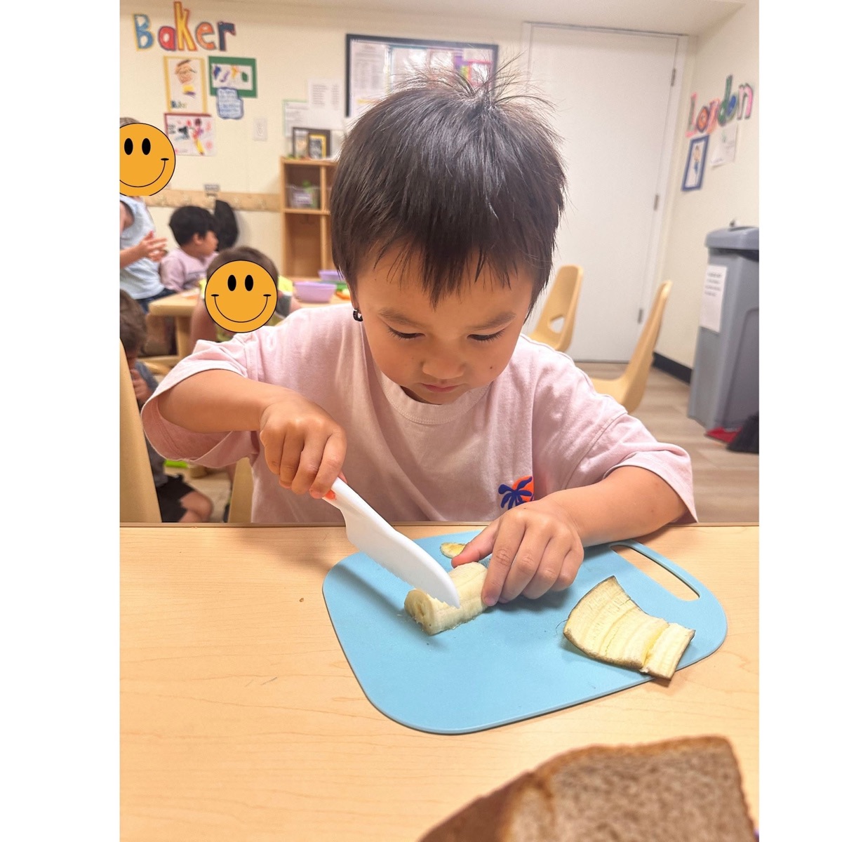 A preschooler slicing fruit with a kid-safe knife during a hands-on cooking activity