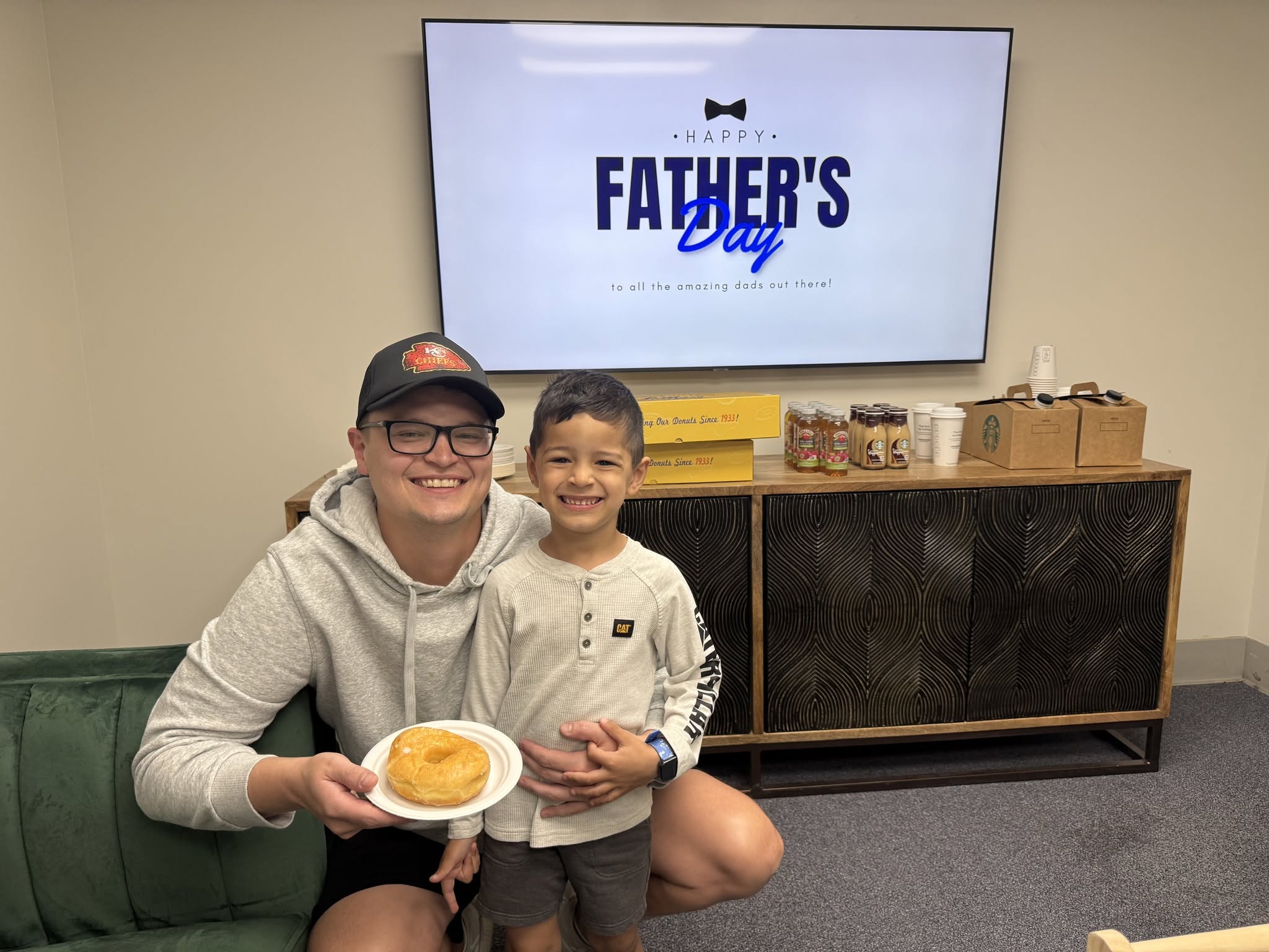 A dad and his son smiling together at a Bright Skies family celebration